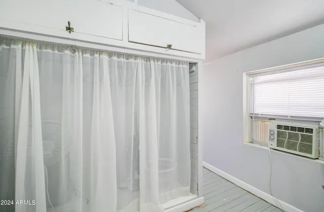 a bedroom with furniture and a rug