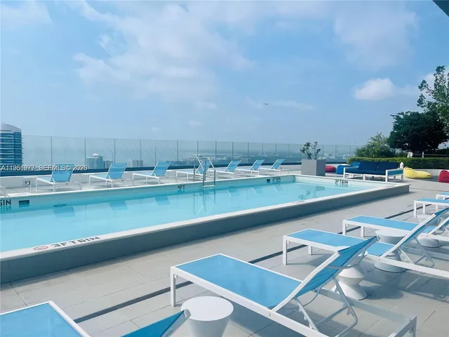 a view of swimming pool with outdoor seating and city view