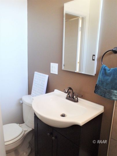 437 North Fairview Street Ridgecrest, CA 93555 - Photo 23 of 35 a bathroom with a sink a toilet and mirror