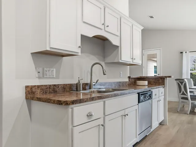 a kitchen with a white cabinets and white appliances