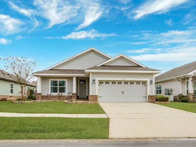 a view of house with yard and entertaining space