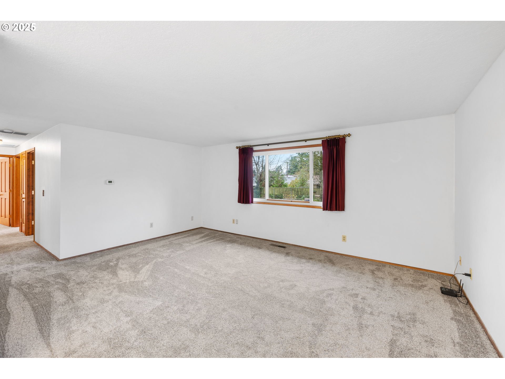 15916 Southeast Brooklyn Street Portland, OR 97236 - Photo 5 of 24 a view of an empty room with a window