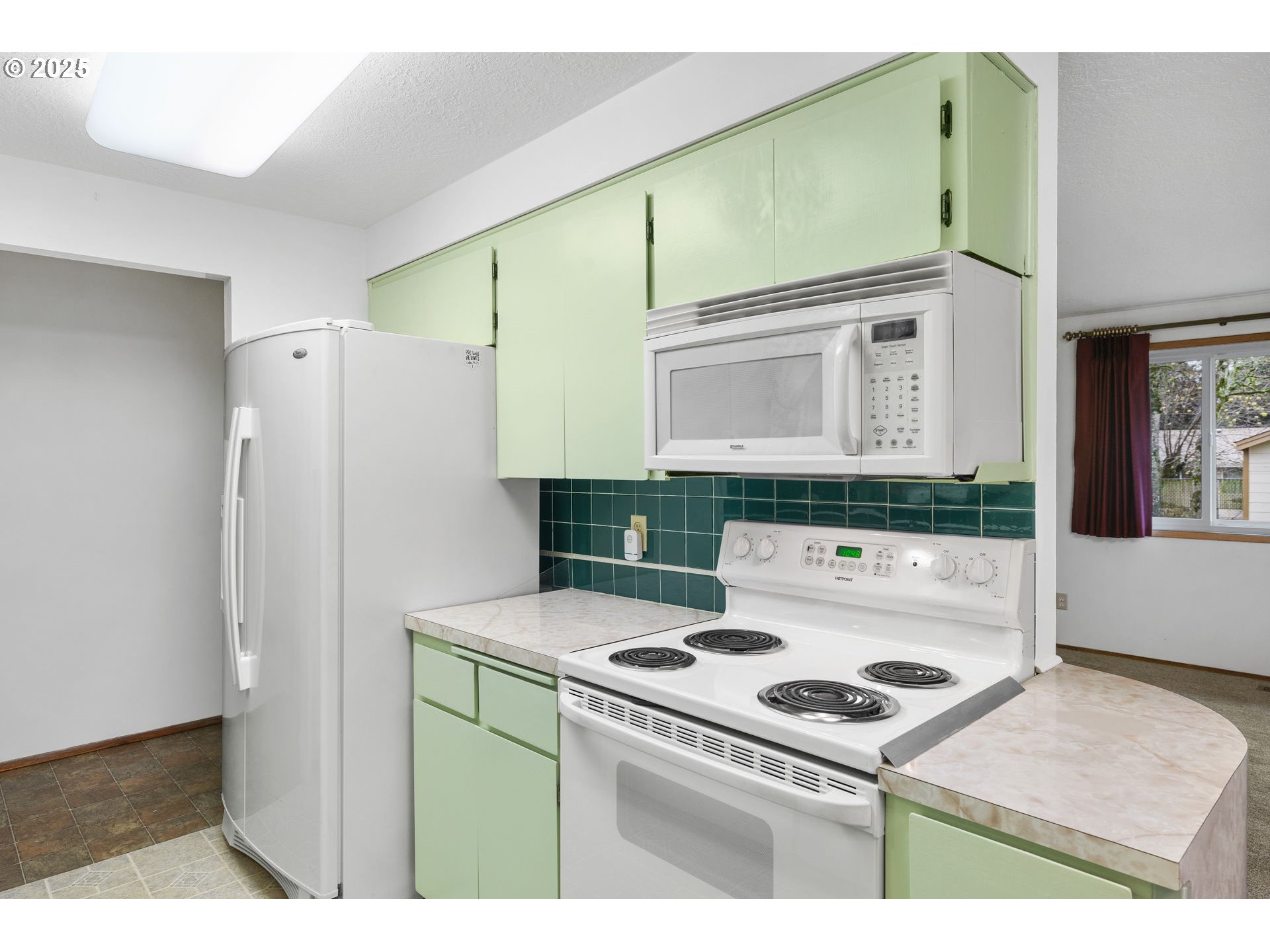 15916 Southeast Brooklyn Street Portland, OR 97236 - Photo 7 of 24 a kitchen that has a stove and a refrigerator
