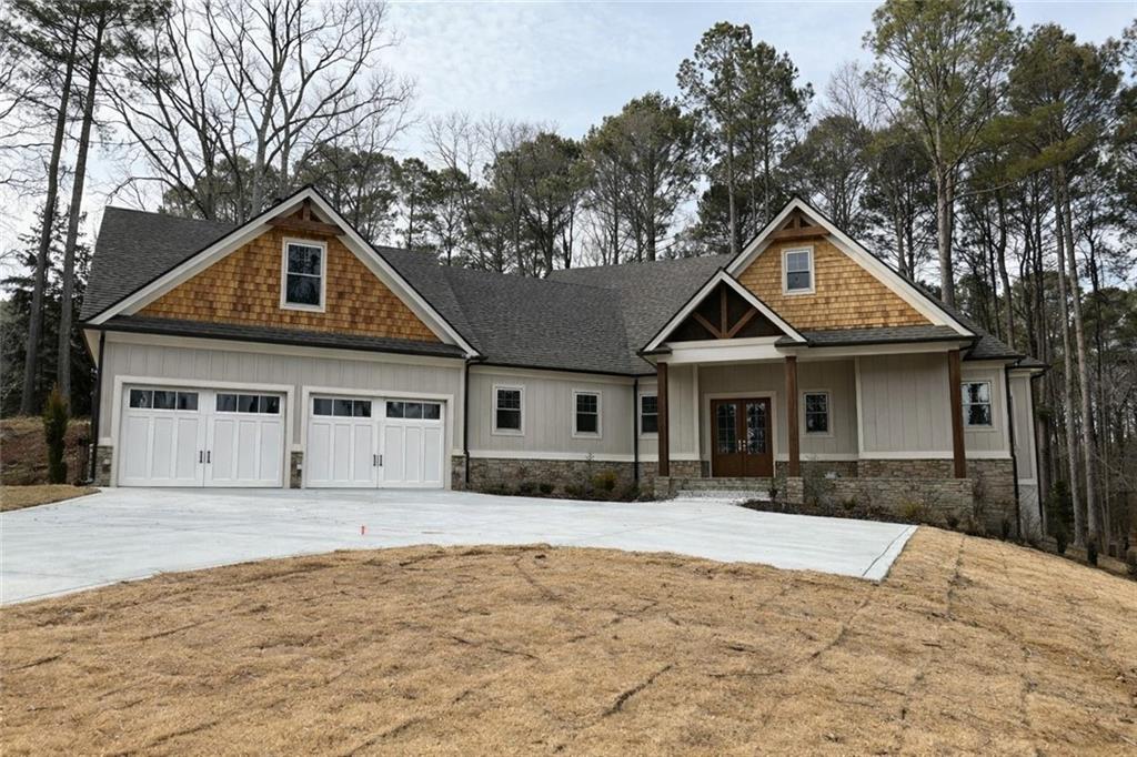 a front view of a house with a yard covered in snow