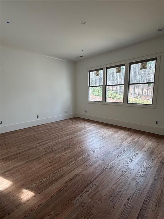 1040 Oak Valley Road Greensboro, GA 30642 - Photo 12 of 20 an empty room with wooden floor and windows