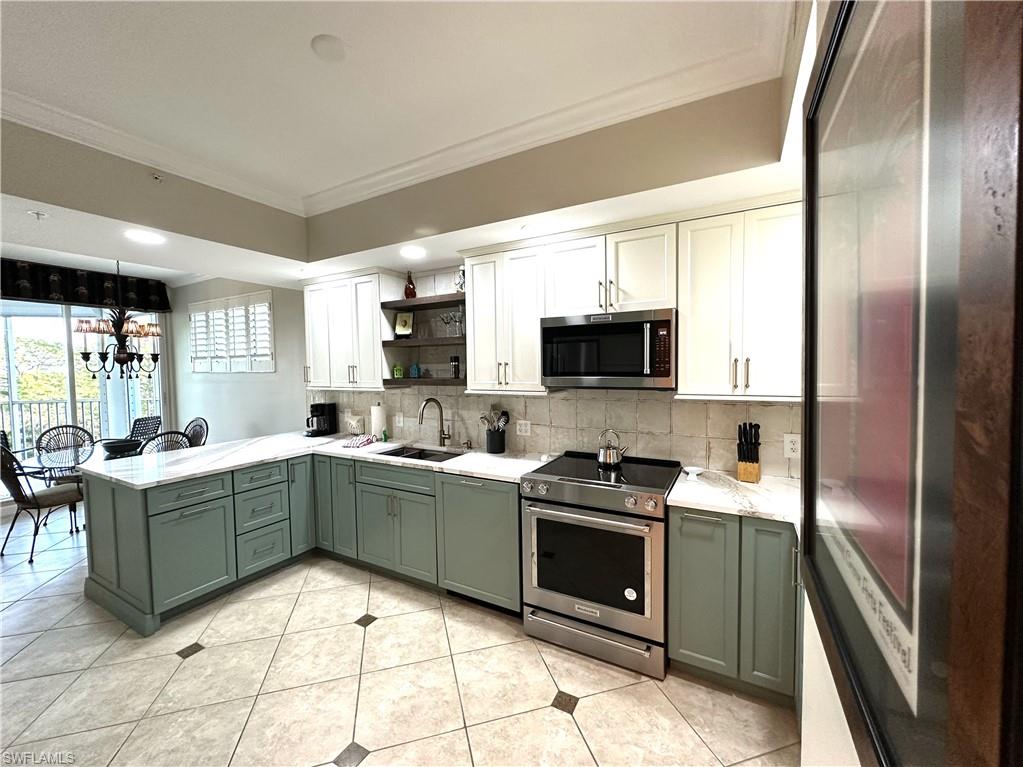 325 Dunes Boulevard, Unit 306 Naples, FL 34110 - Photo 8 of 40 a kitchen with stainless steel appliances granite countertop a refrigerator a stove top oven a sink and dishwasher