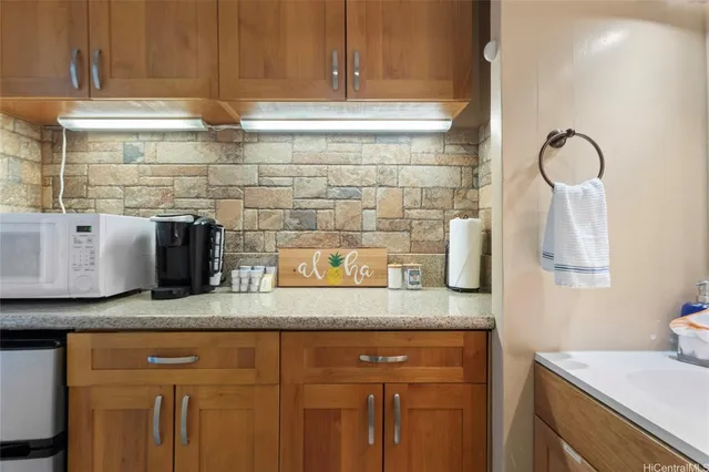 a kitchen with granite countertop stainless steel appliances a sink and cabinets