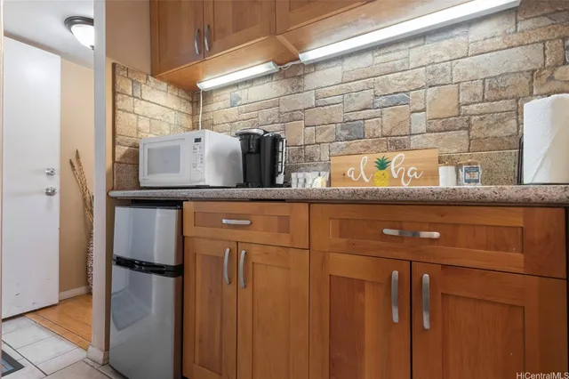 a kitchen with a refrigerator and cabinets