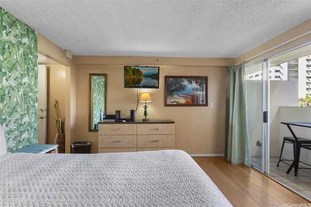 a room with a bed and a dresser in it