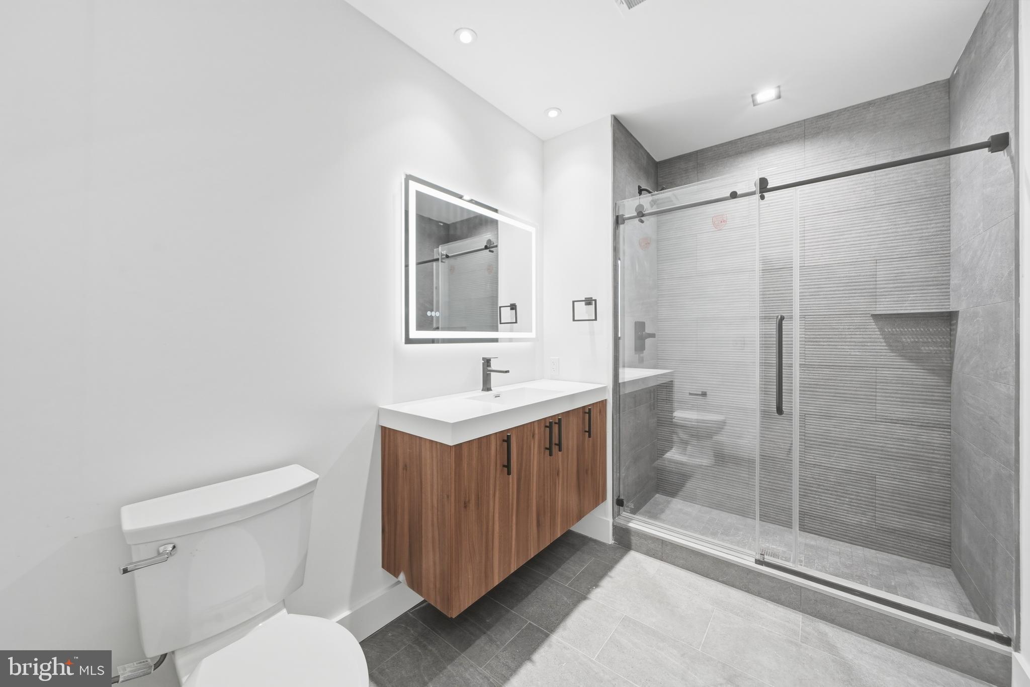 326 North 12th Street, Unit 405 Philadelphia, PA 19107 - Photo 13 of 22 a bathroom with a sink toilet and shower
