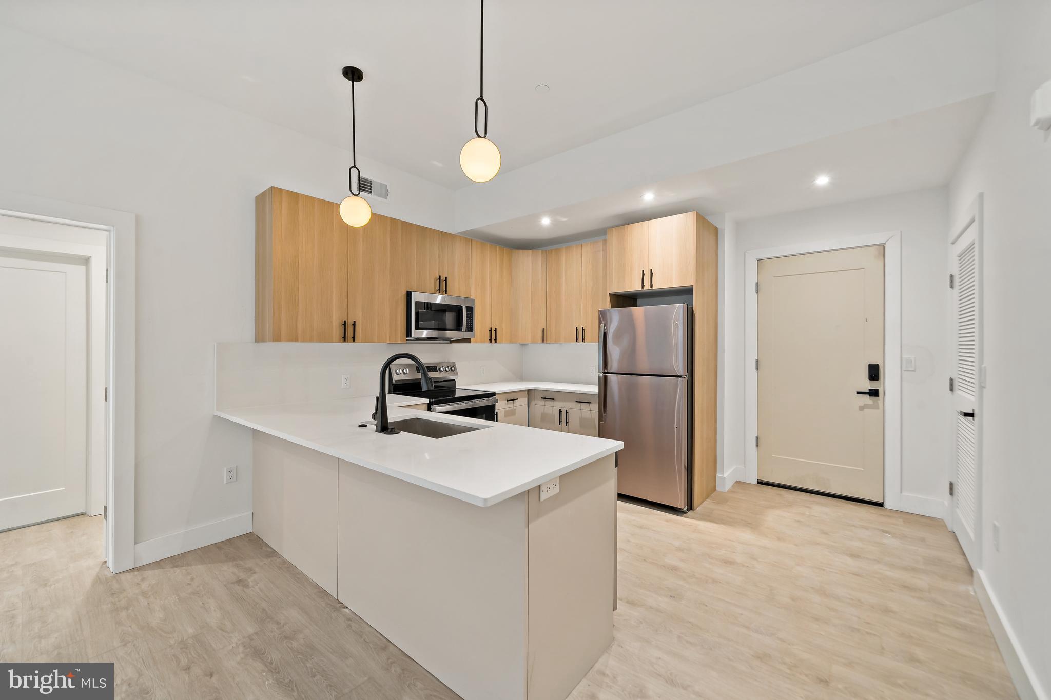 326 North 12th Street, Unit 405 Philadelphia, PA 19107 - Photo 18 of 22 a kitchen with refrigerator cabinets and a sink