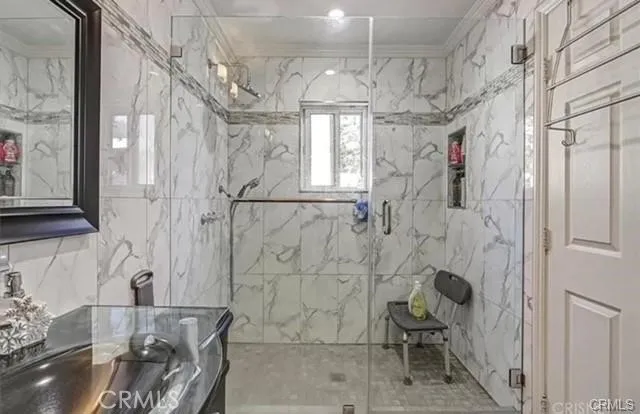 a bathroom with a granite countertop shower a sink and a toilet