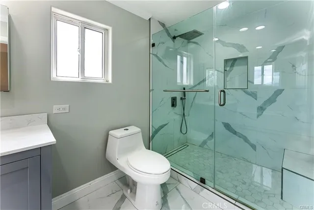 a bathroom with a toilet a sink and shower