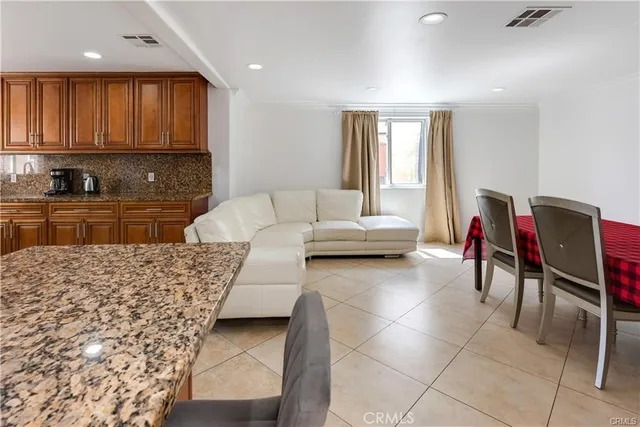 a living room with furniture and kitchen view