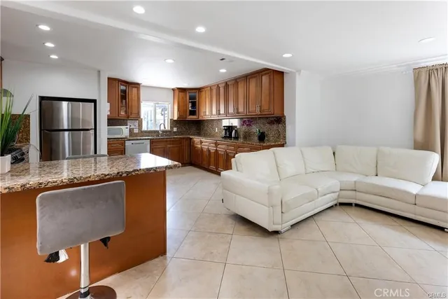 a living room with kitchen island furniture and a kitchen view