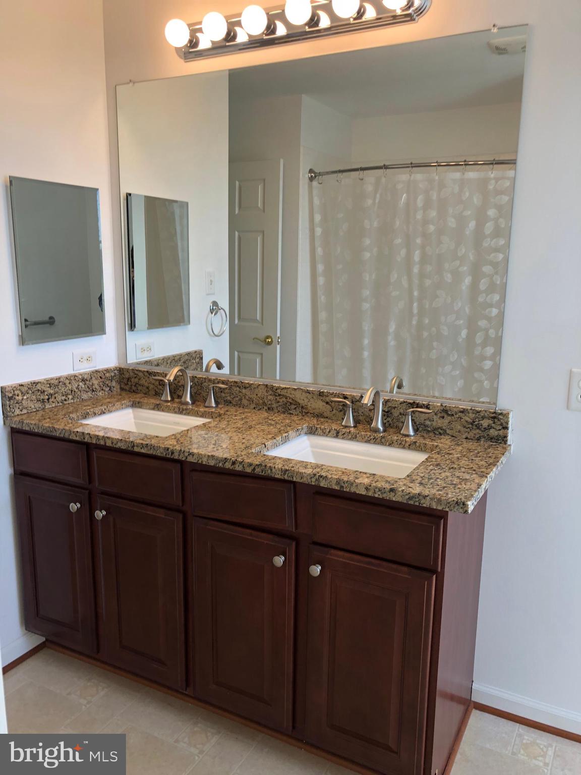 12550 Shoemaker Road Taneytown, MD 21787 - Photo 29 of 40 a bathroom with a granite countertop sink and a mirror