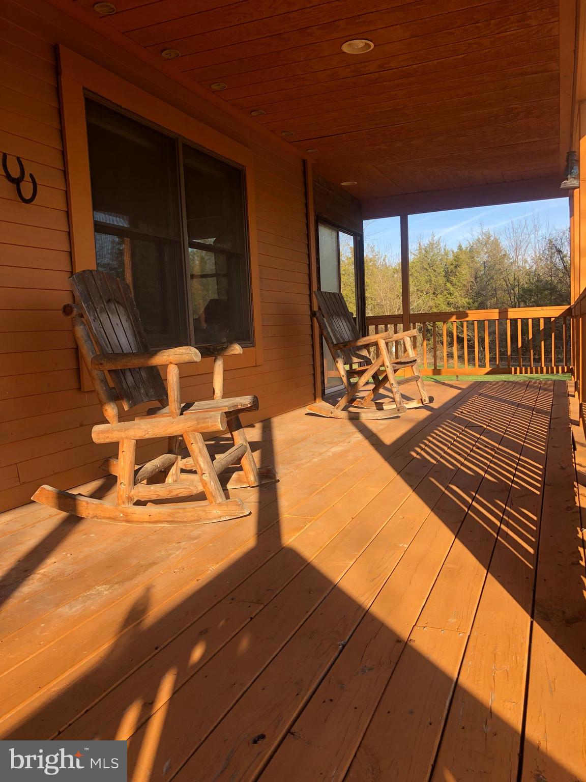 12550 Shoemaker Road Taneytown, MD 21787 - Photo 3 of 40 a view of a balcony with chairs and wooden floor