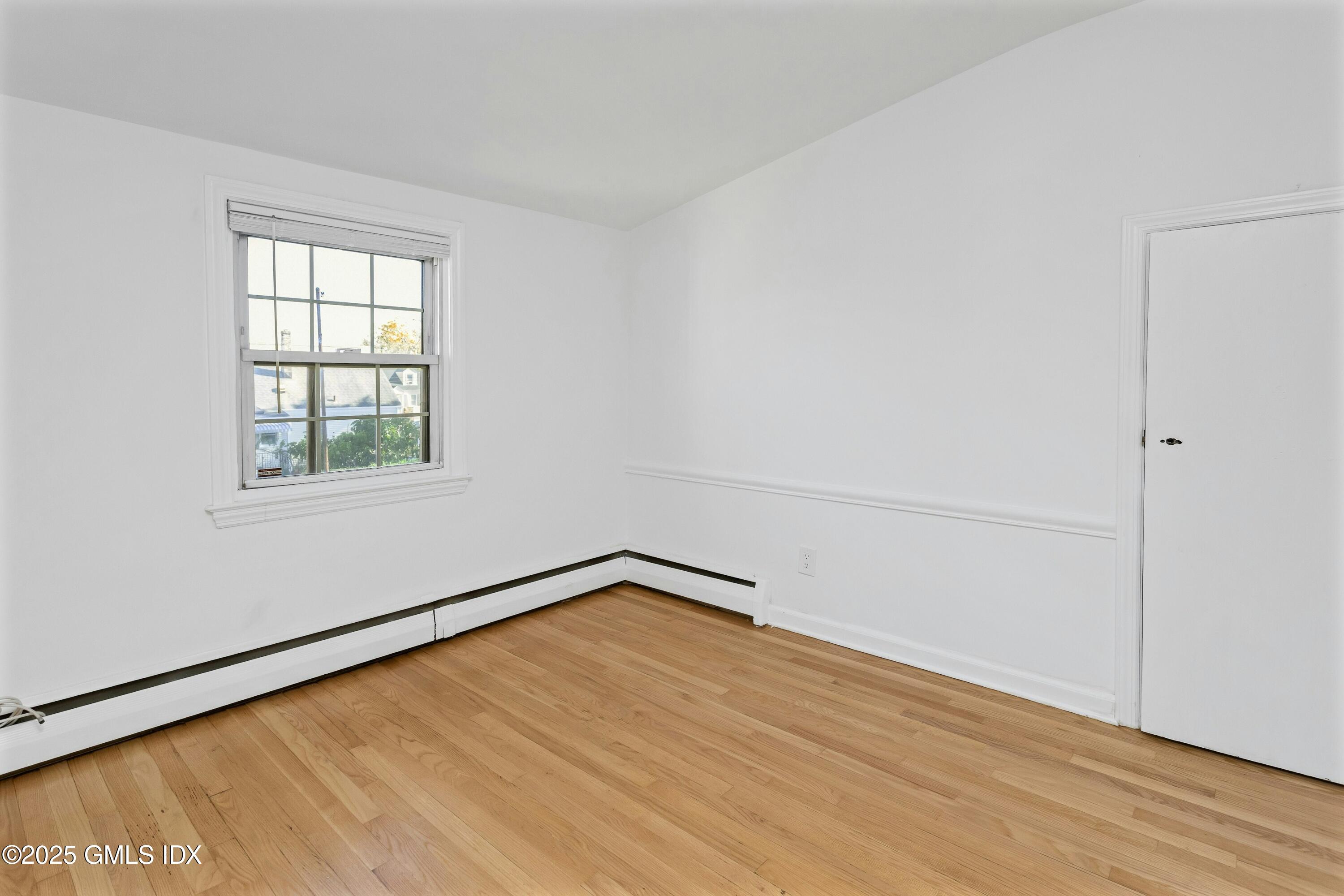 80 Victory Street, Unit B Stamford, CT 06902 - Photo 11 of 12 an empty room with wooden floor and windows