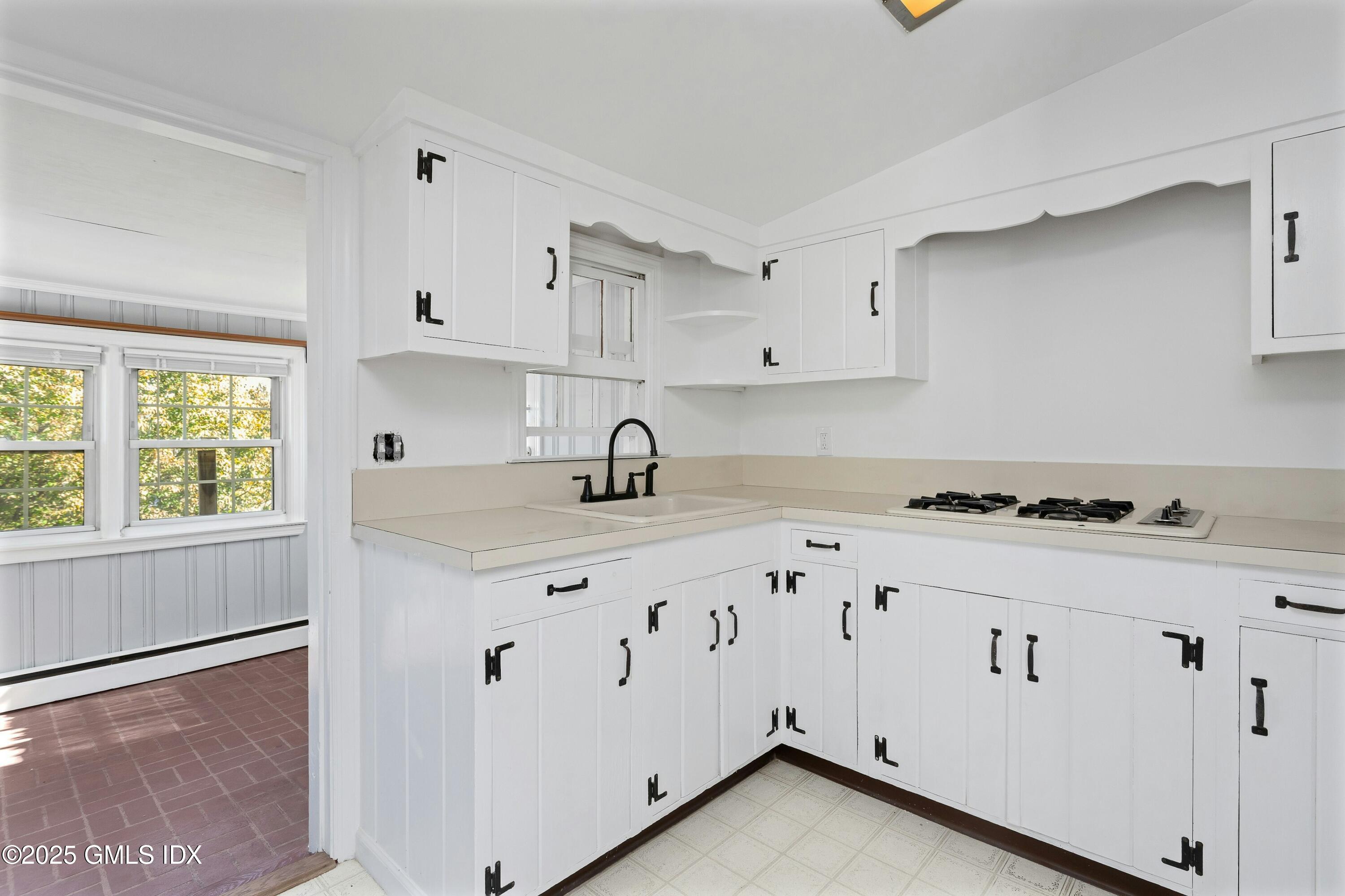 80 Victory Street, Unit B Stamford, CT 06902 - Photo 5 of 12 a kitchen with granite countertop white cabinets and white appliances
