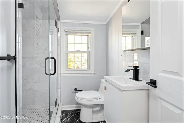 a bathroom with a toilet sink and shower