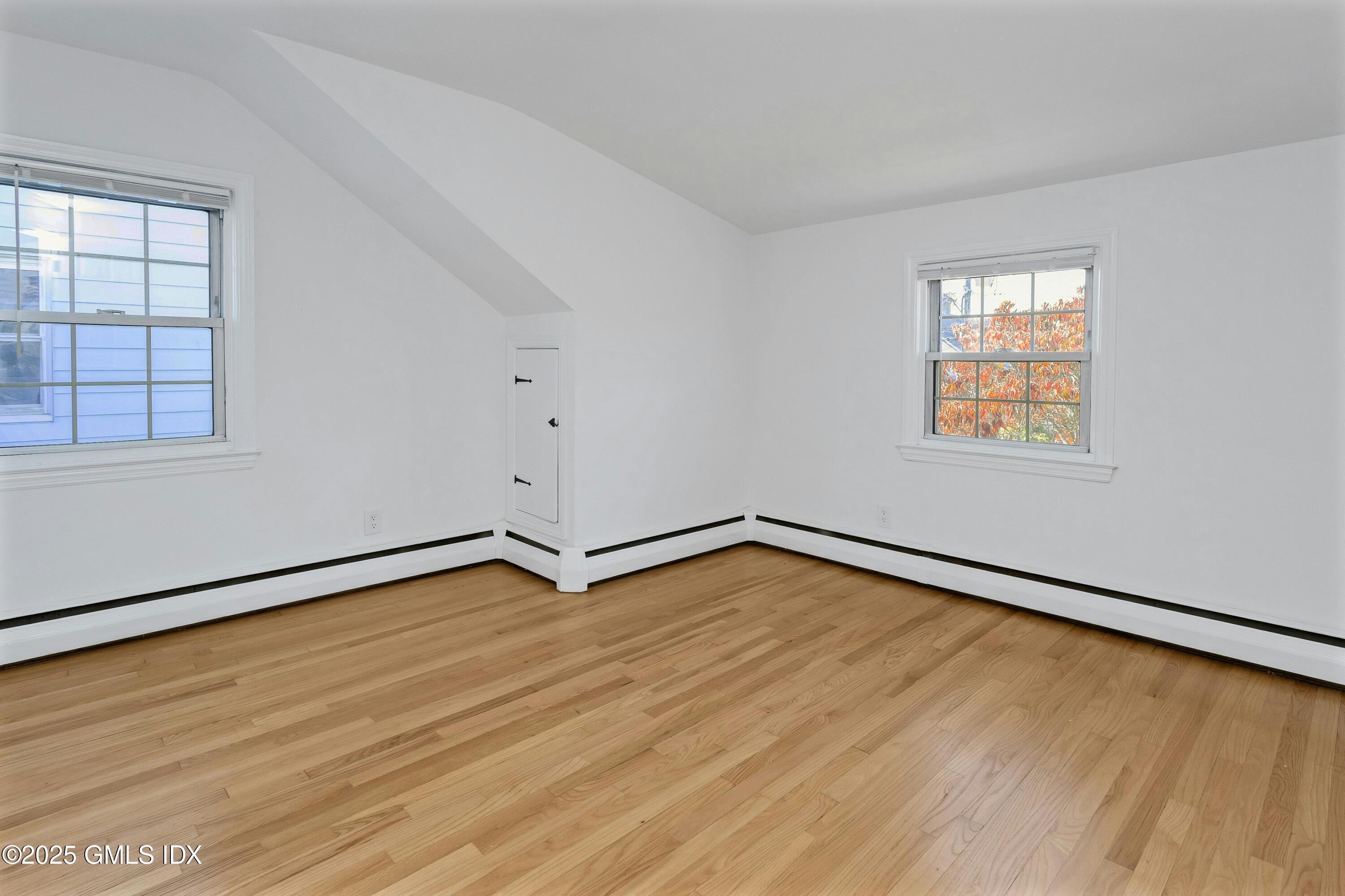 80 Victory Street, Unit B Stamford, CT 06902 - Photo 10 of 12 an empty room with wooden floor and windows