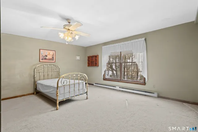 a bedroom with a bed and a painting on the wall