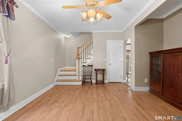 a view of empty room with wooden floor