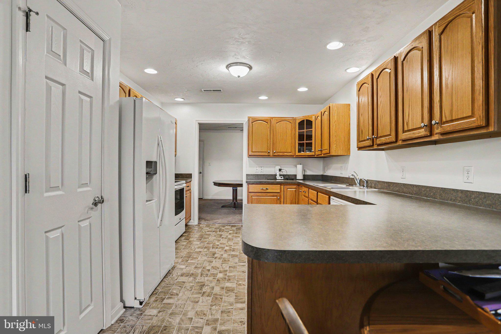 1371 Chami Drive, Unit 166 Spring Grove, PA 17362 - Photo 15 of 28 a kitchen with stainless steel appliances granite countertop a refrigerator a sink dishwasher a stove and a sink with wooden floor