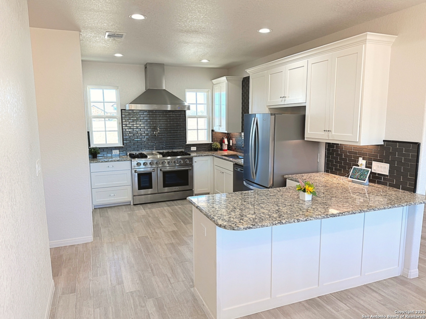 469 Buckskin Trail Bandera, TX 78003 - Photo 4 of 13 a kitchen with stainless steel appliances granite countertop a sink stove and refrigerator