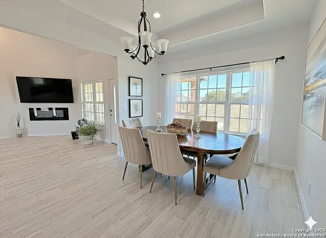 a view of a dining room with furniture window and wooden floor