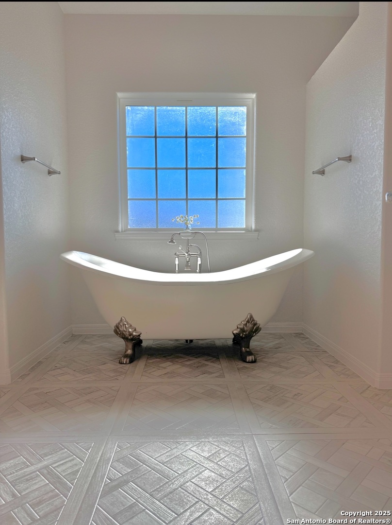 469 Buckskin Trail Bandera, TX 78003 - Photo 8 of 13 a bathroom with a tub and a window