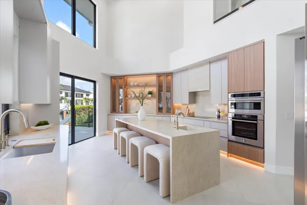 a kitchen with a table chairs sink and cabinets