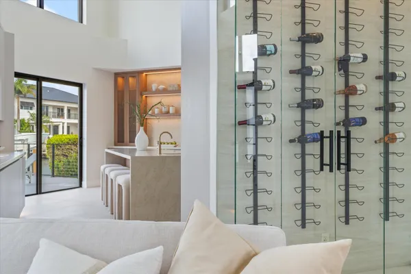 a large white kitchen with kitchen island a sink stainless steel appliances and cabinets