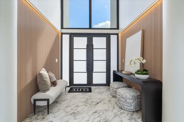 a dining room with furniture a flat screen tv and a window