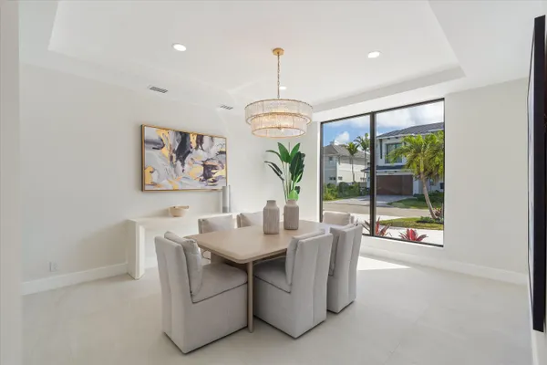 a bedroom with furniture and large windows