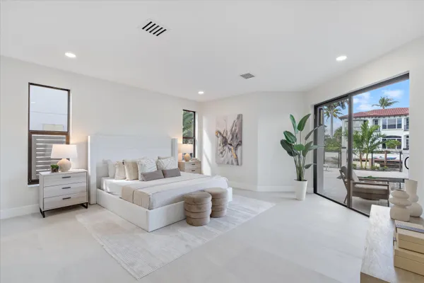an empty room with windows and ceiling fan
