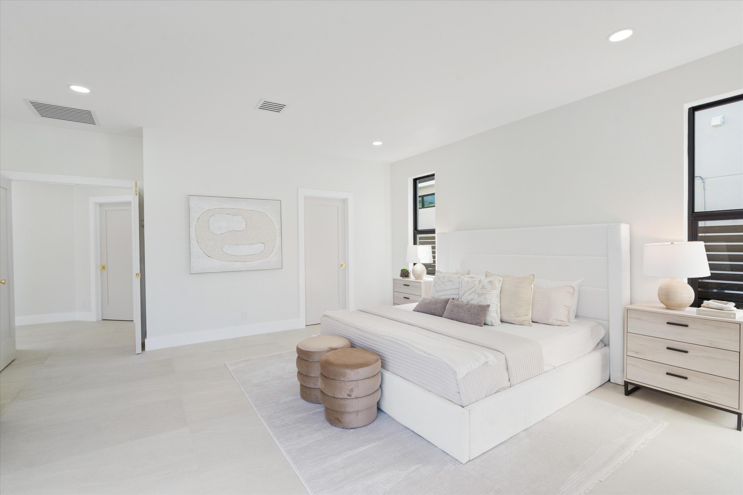 3721 Northeast 30th Avenue Lighthouse Point, FL 33064 - Photo 27 of 70 a bedroom with bed and white walls
