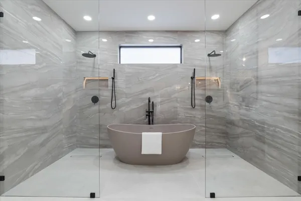 a bathroom with a double vanity sink and mirror with shower