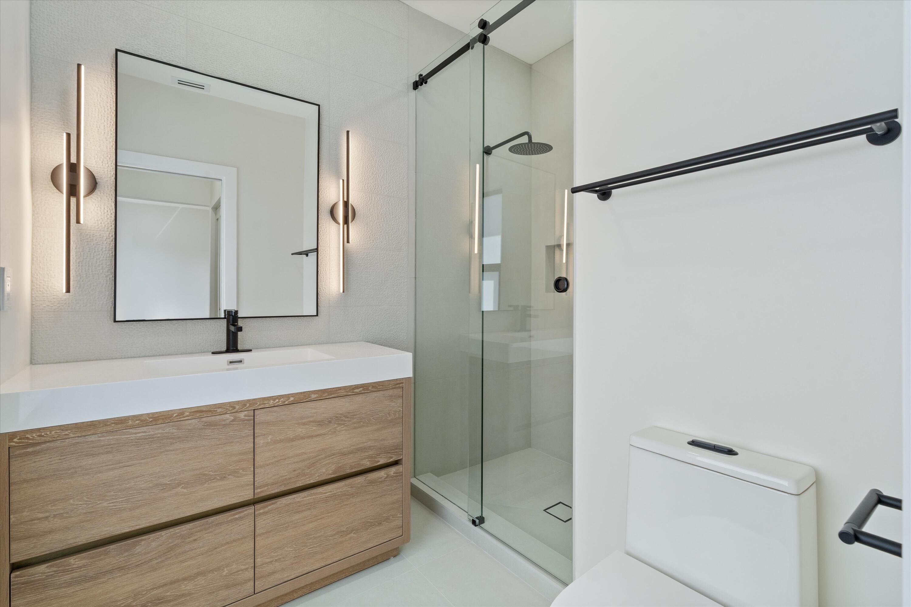 3721 Northeast 30th Avenue Lighthouse Point, FL 33064 - Photo 44 of 70 a bathroom with a shower and a sink