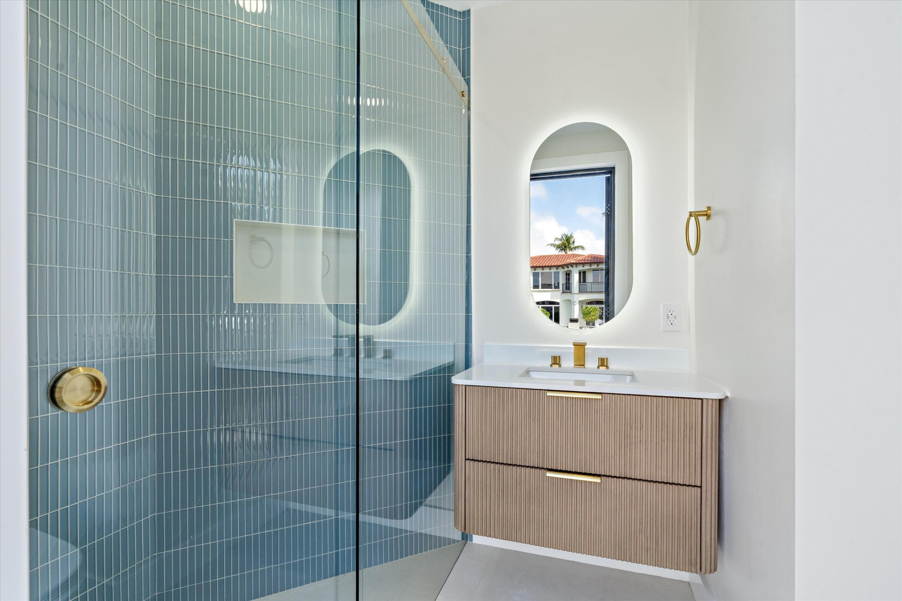 3721 Northeast 30th Avenue Lighthouse Point, FL 33064 - Photo 48 of 70 a bathroom with a sink mirror and shower