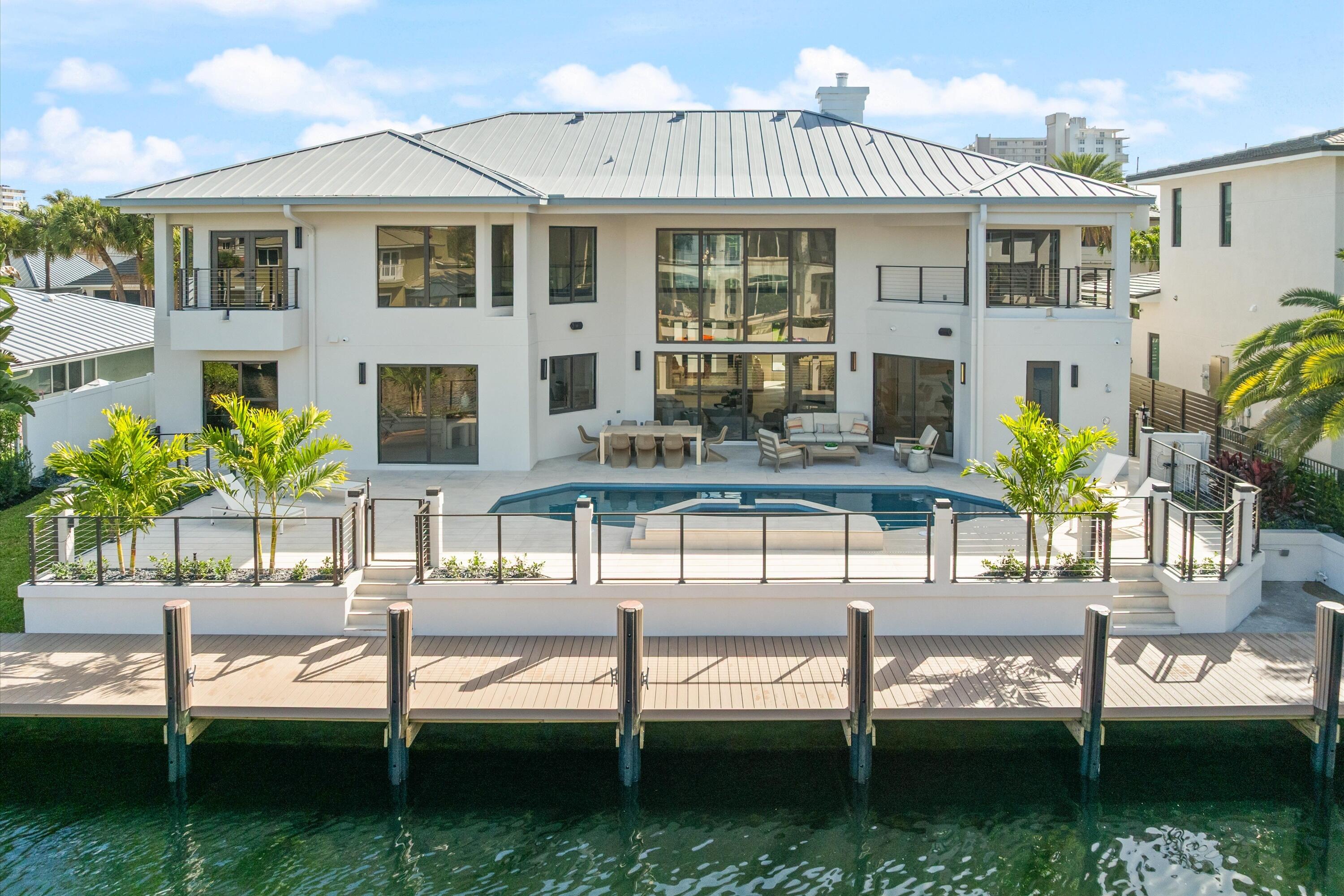 3721 Northeast 30th Avenue Lighthouse Point, FL 33064 - Photo 53 of 70 a front view of house with yard and outdoor seating