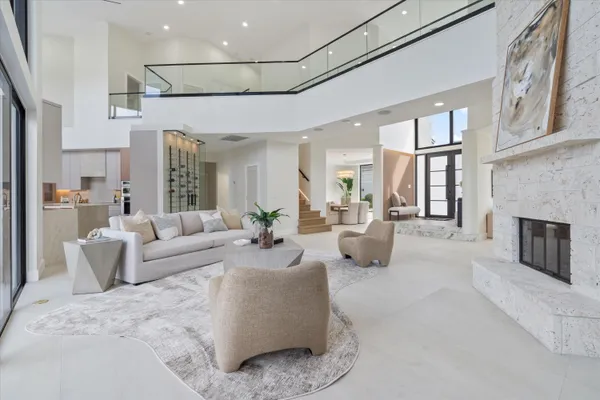a living room with furniture and a floor to ceiling window