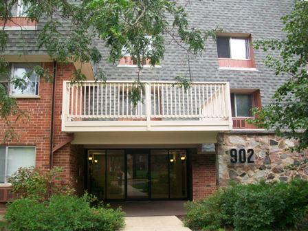 902 Ridge Square, Unit 209 Elk Grove Village, IL 60007 - Photo 1 of 1 a front view of a house with a balcony
