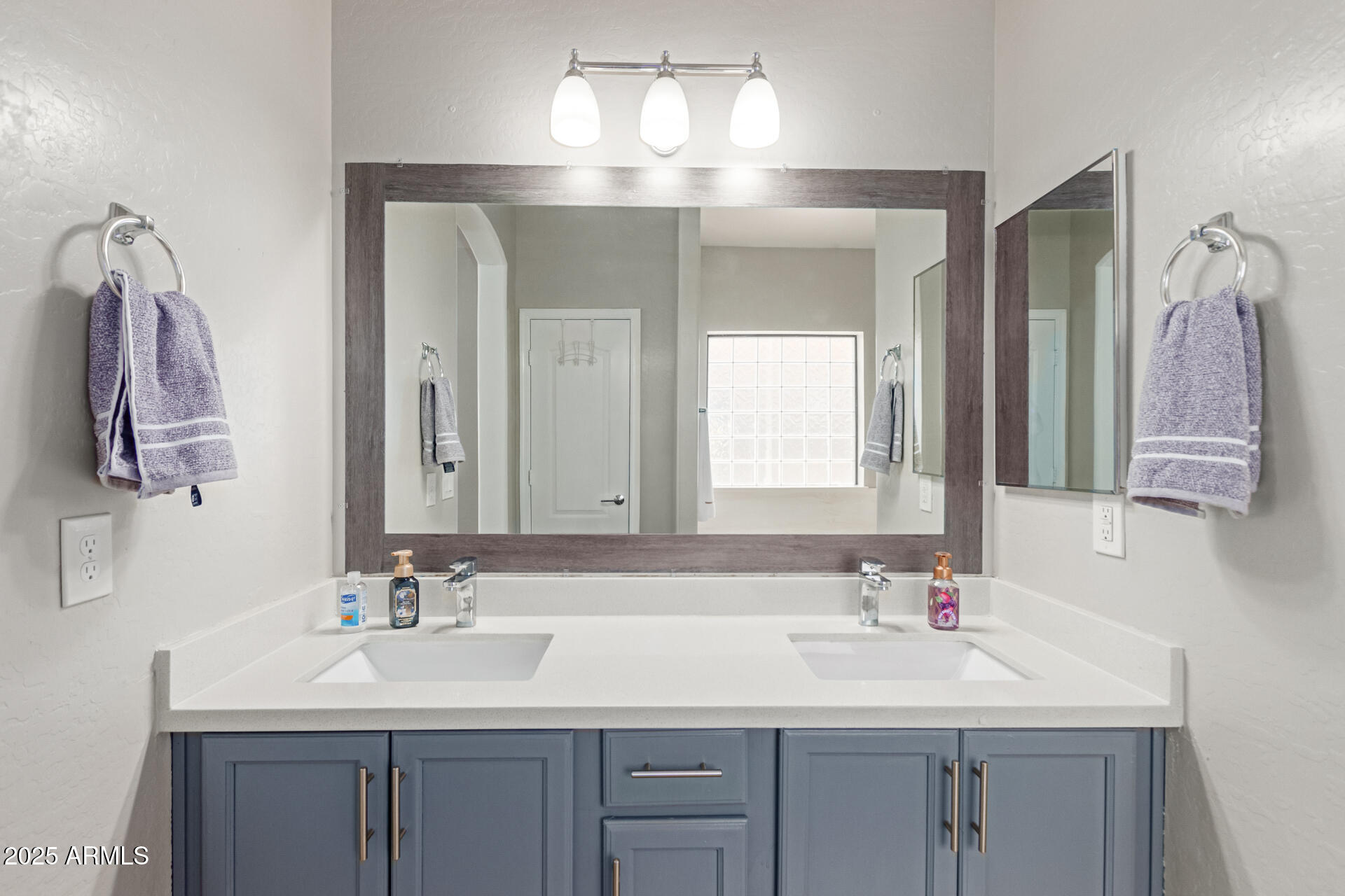 8632 South 10th Lane Phoenix, AZ 85041 - Photo 11 of 31 a bathroom with a sink and a mirror