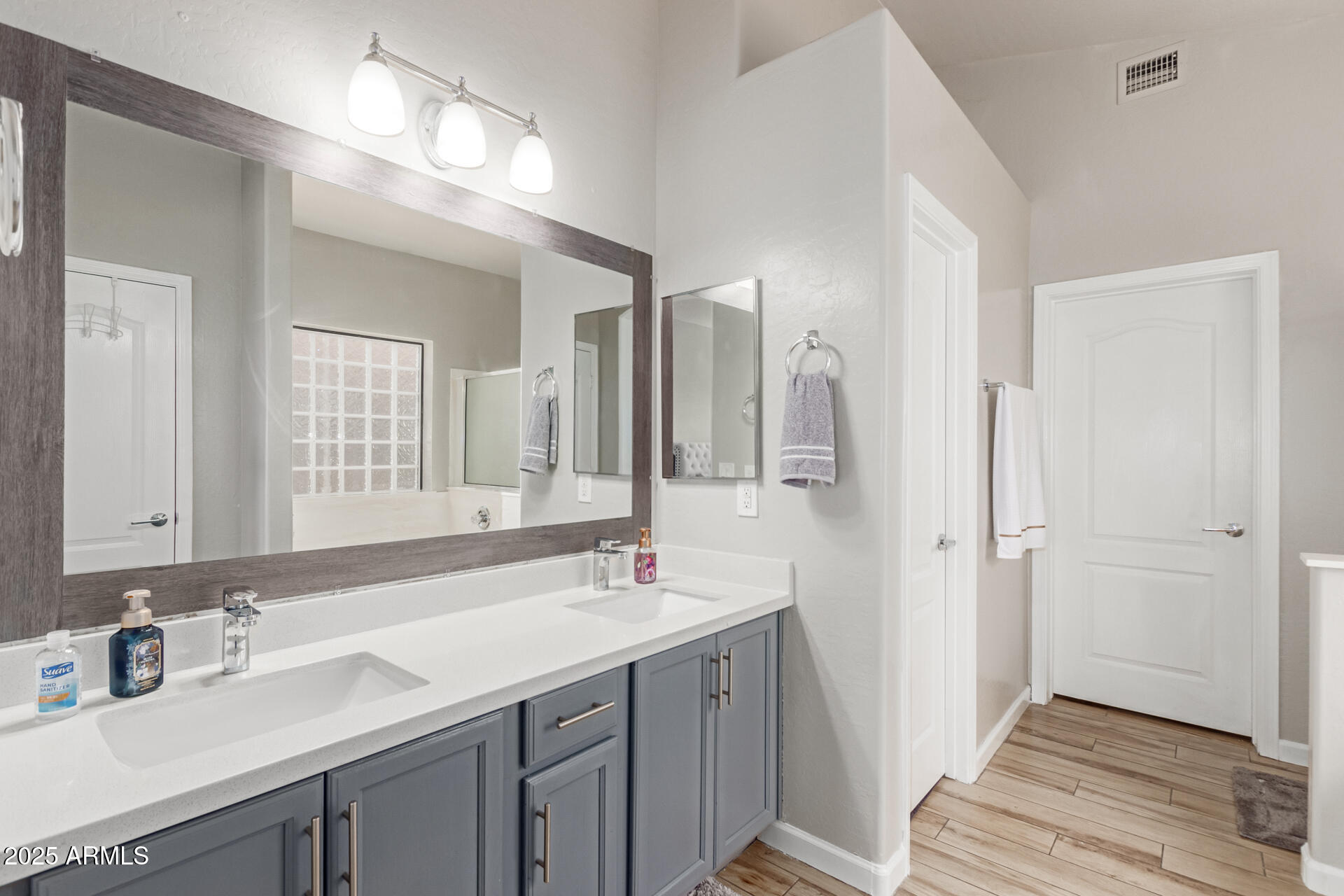 8632 South 10th Lane Phoenix, AZ 85041 - Photo 12 of 31 a bathroom with a sink double vanity and a mirror