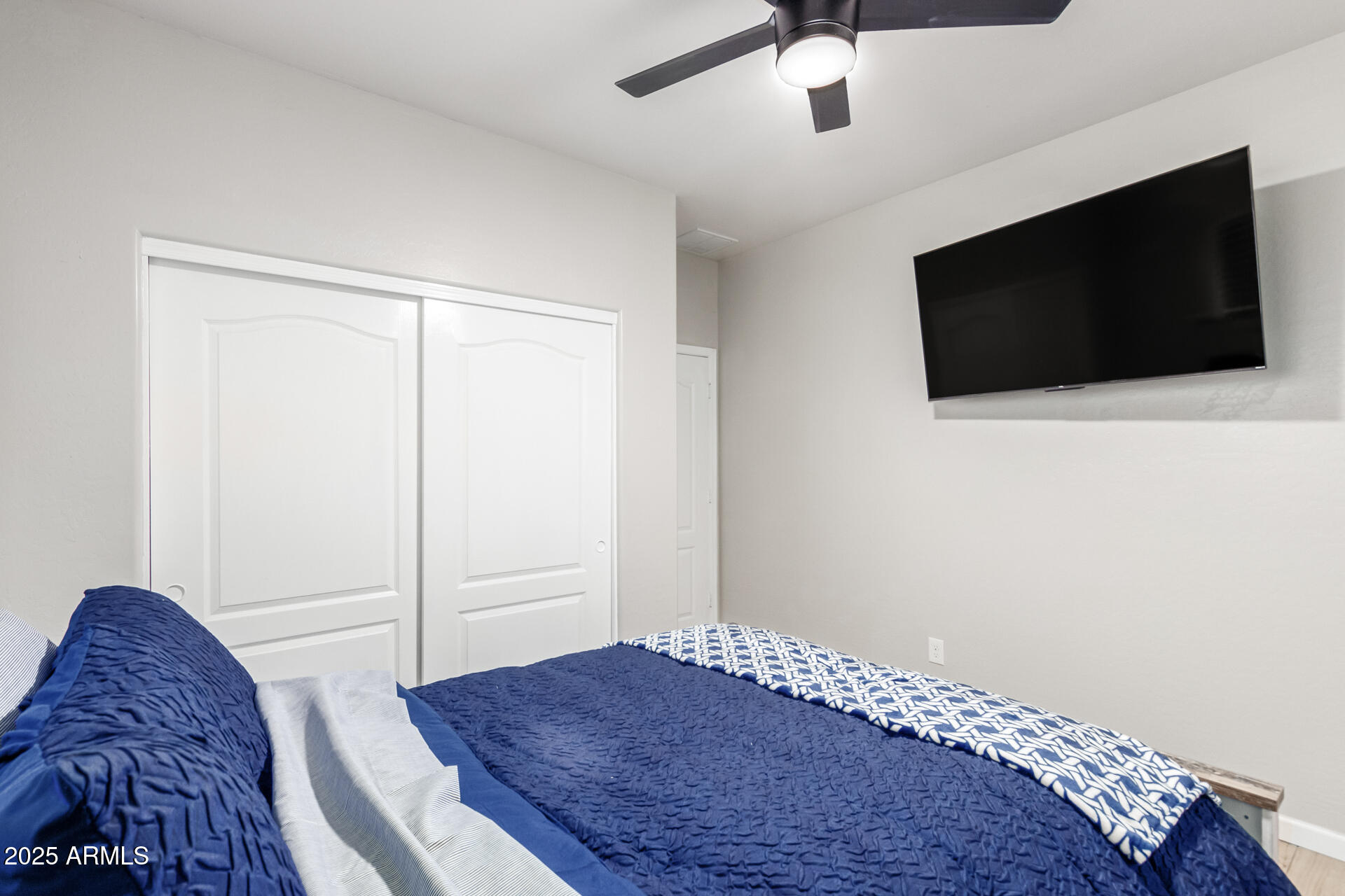 8632 South 10th Lane Phoenix, AZ 85041 - Photo 14 of 31 a bedroom with a bed and a flat screen tv