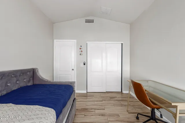 a bedroom with a bed and a table