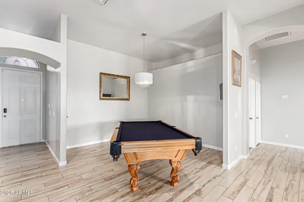 a room with wooden floor and furniture