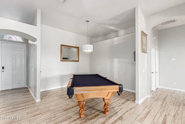 a room with wooden floor and furniture