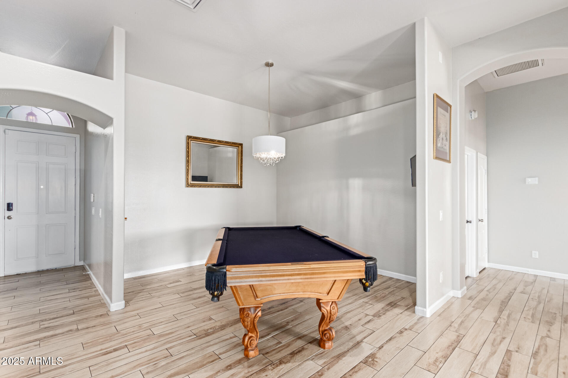 8632 South 10th Lane Phoenix, AZ 85041 - Photo 4 of 31 a room with wooden floor and furniture